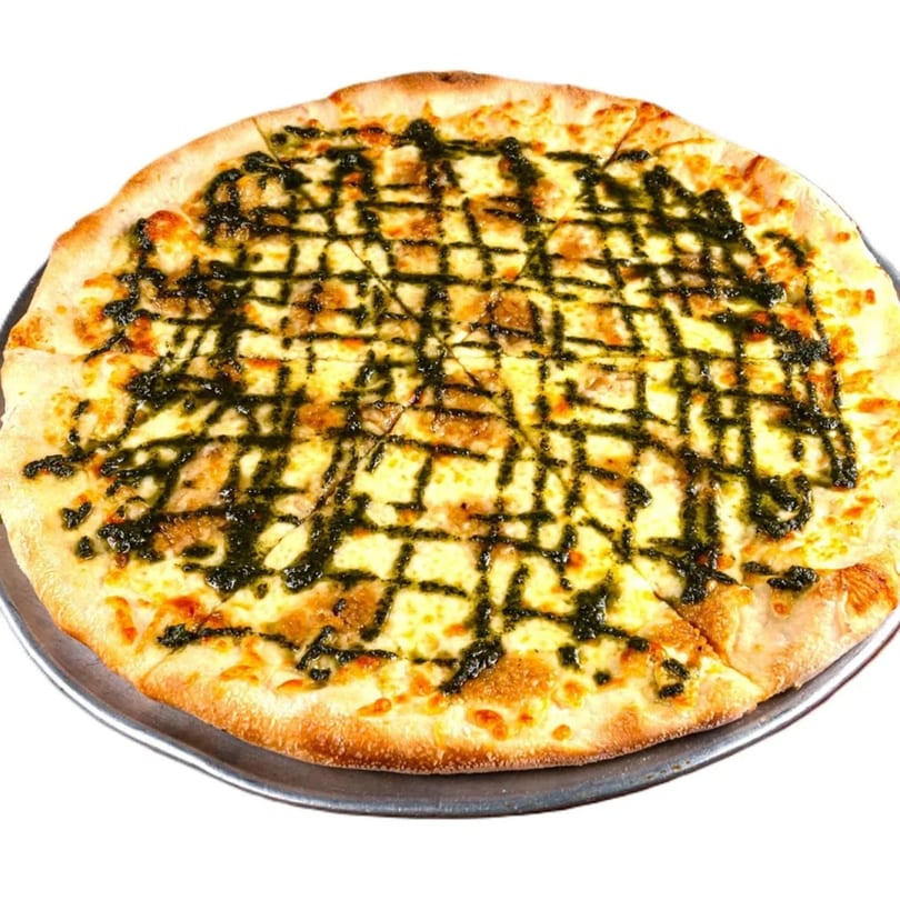 GoGo Pizza's pesto pizza, with a golden crust, melted cheese, and a dark green pesto drizzle.